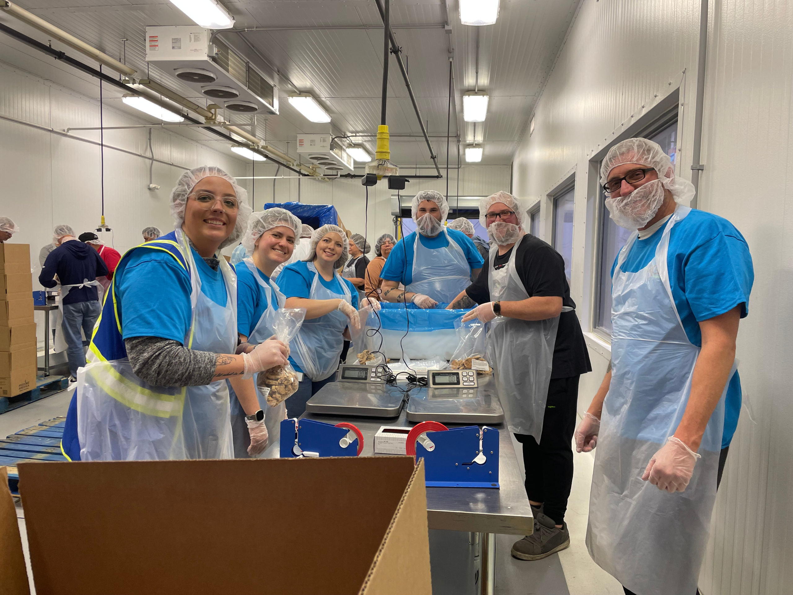 Group of RGL teammates volunteer bagging cookies at Feeding America in Appleton Wisconsin