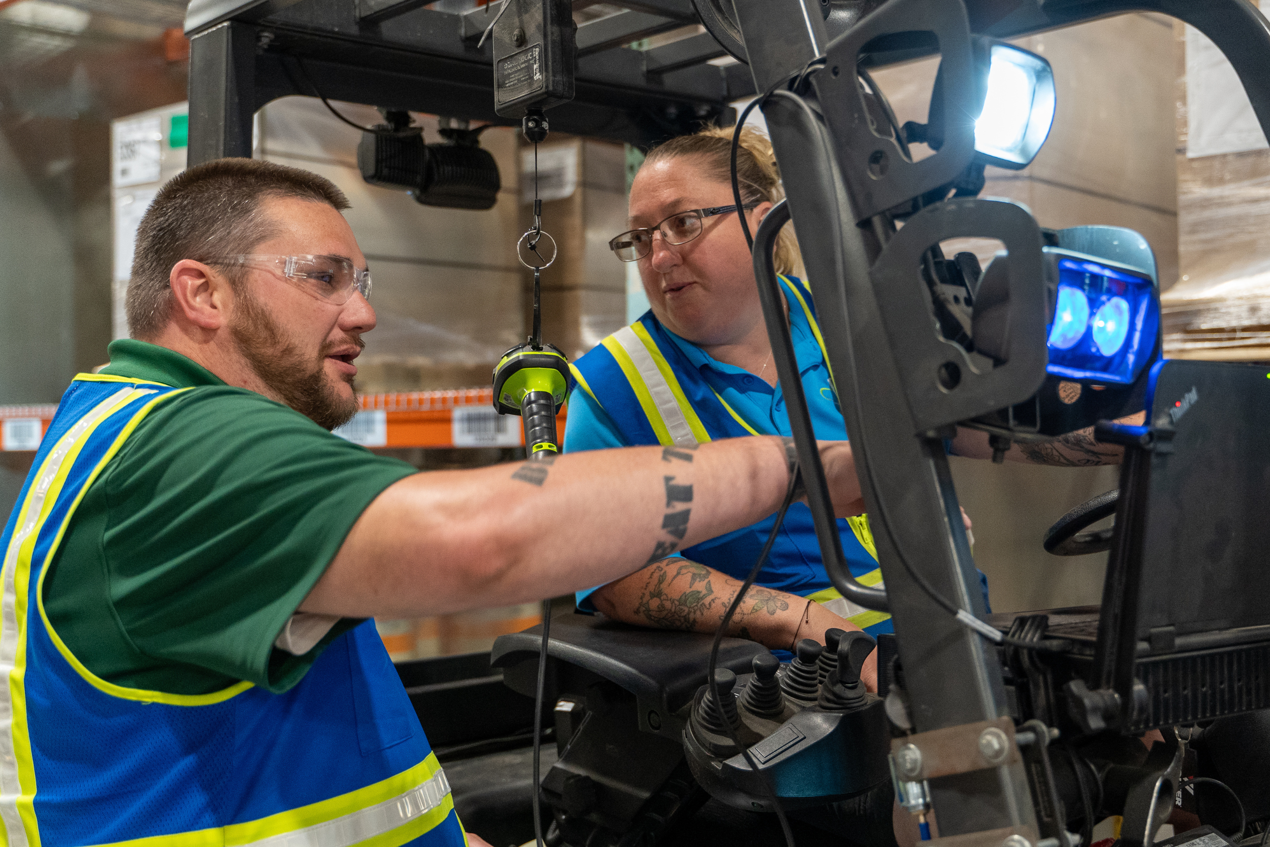 Warehouse team leaders conversation on forklift